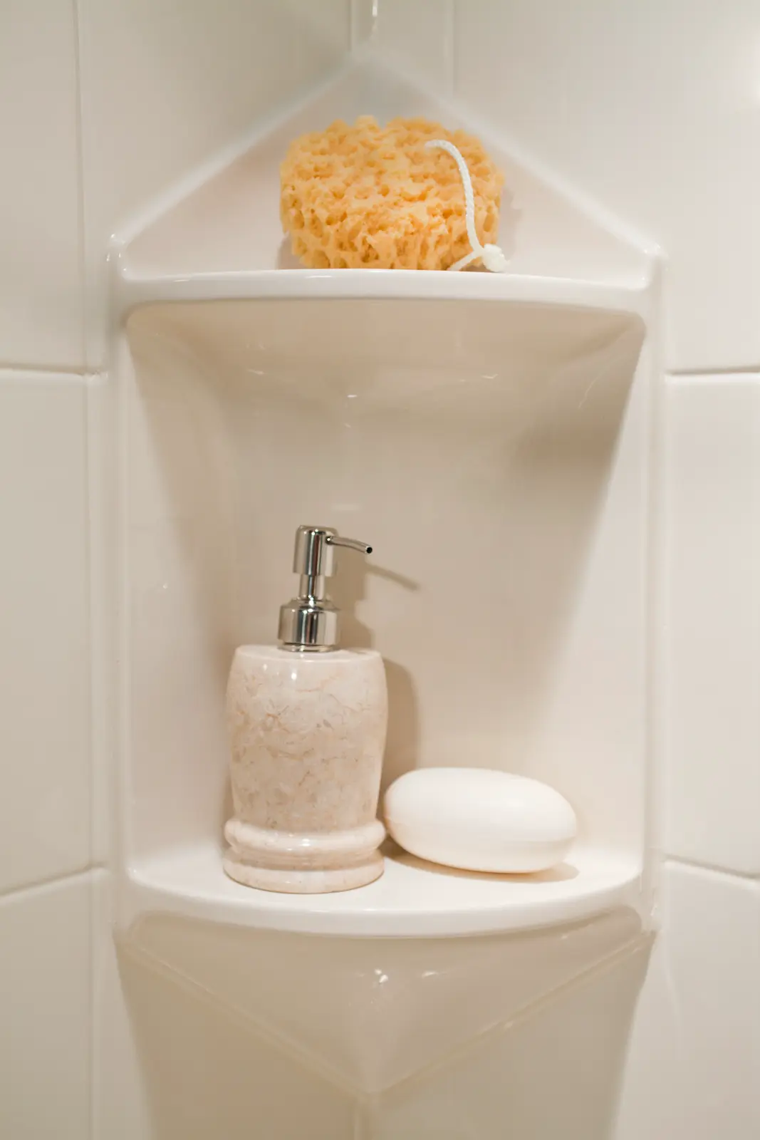 Two-shelf corner caddy in almond tile wall