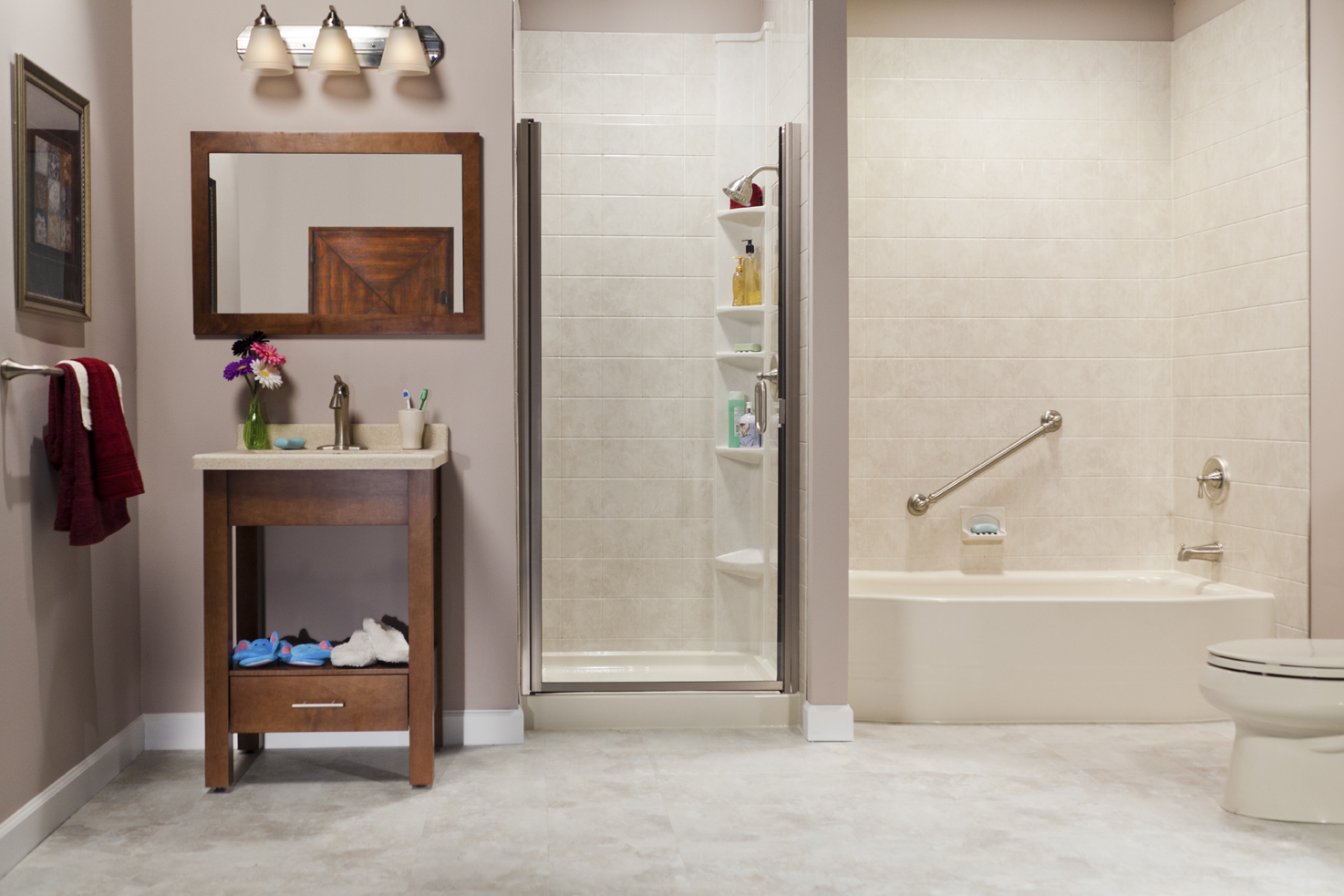 Showroom with biscuit bath, shower, vanity, and travertine tile