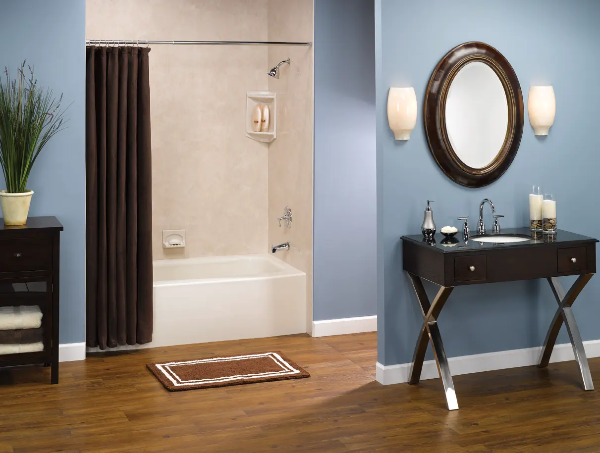 Biscuit tub with travertine smooth walls in blue bathroom with dark vanity