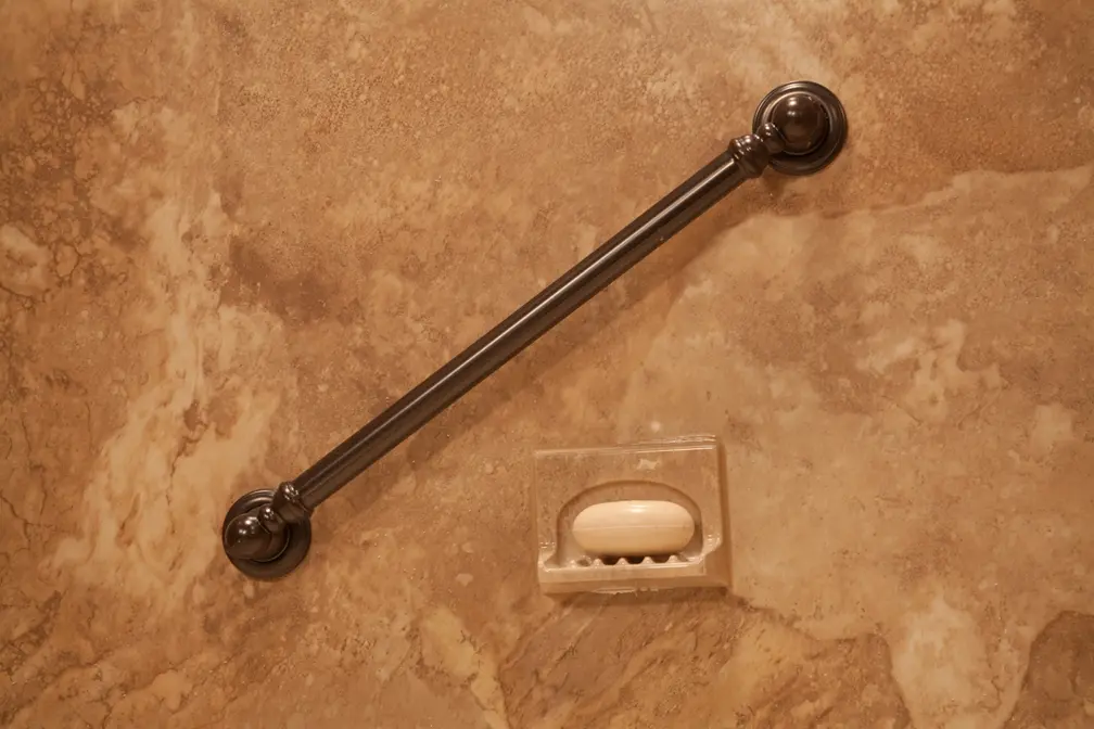 Oil-rubbed bronze grab bar on Venetian granite walls