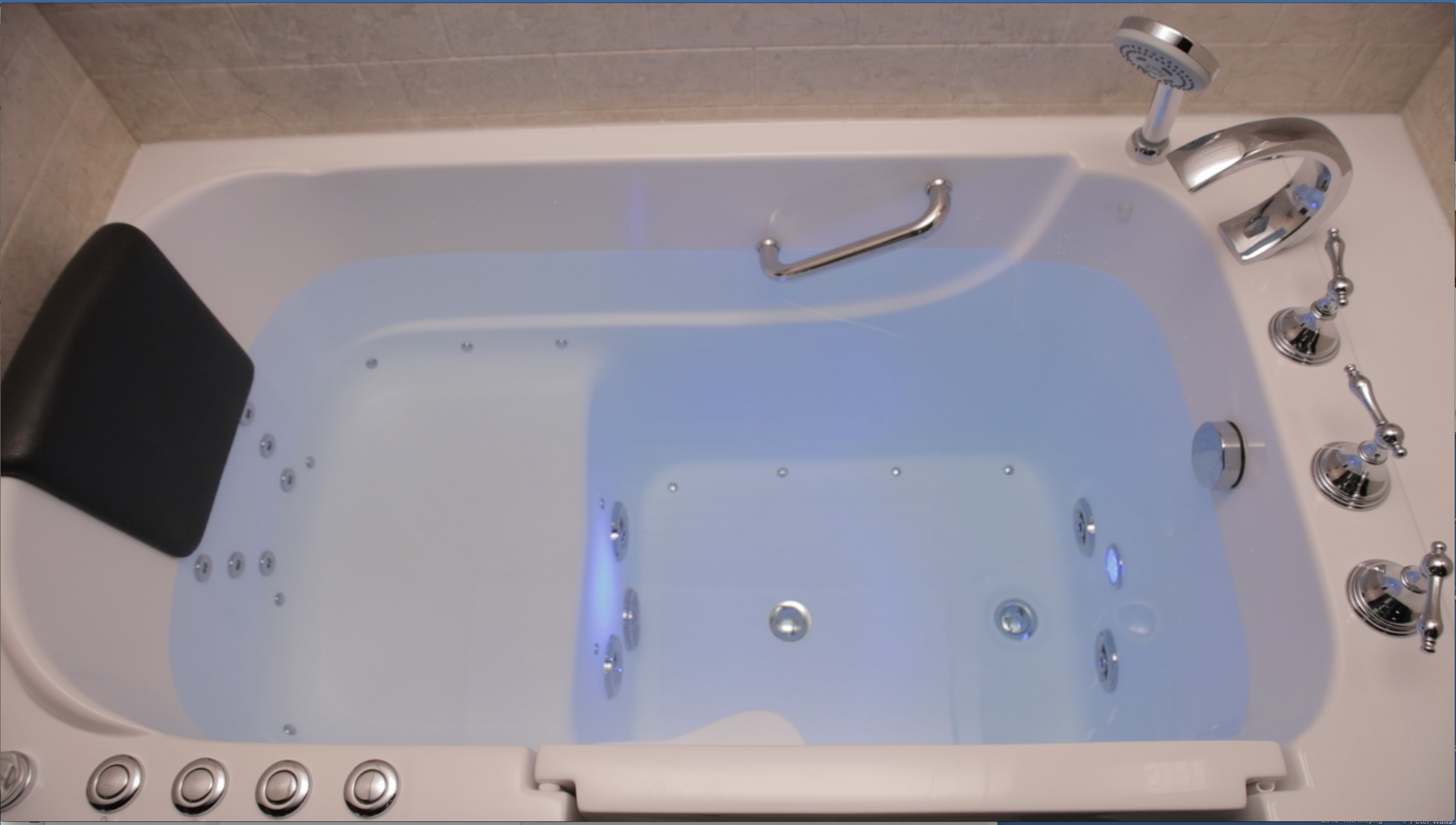Walk-in tub top view with blue chromotherapy lighting and hydrotherapy jets