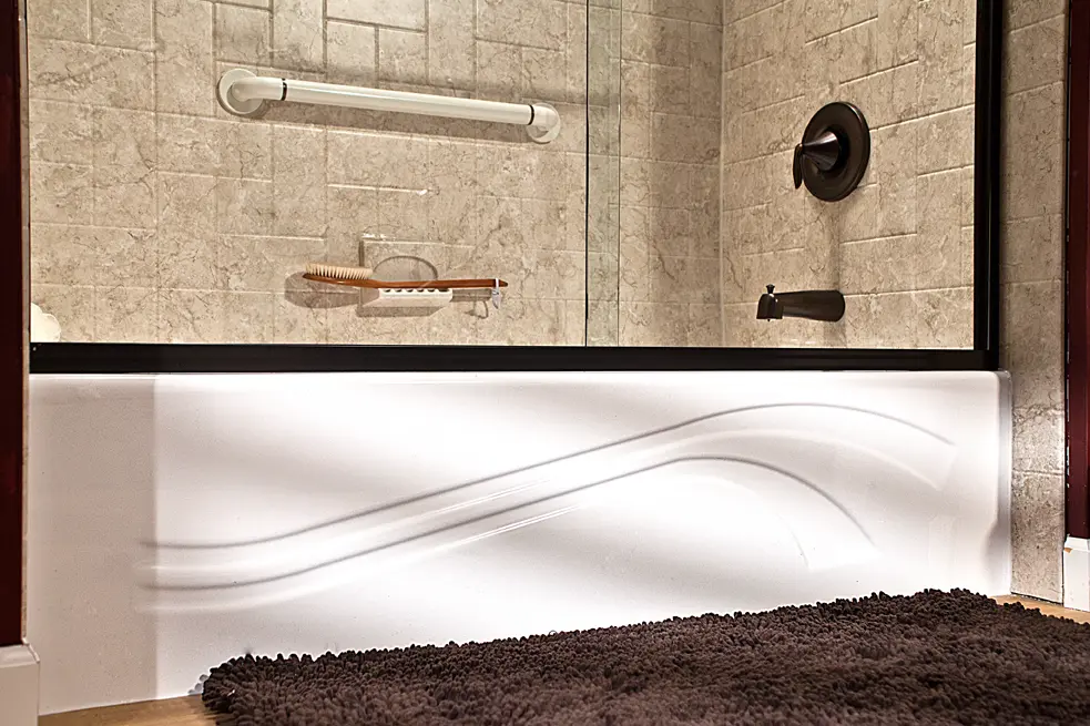 Wave tub close-up with brecchia windmill walls and oil-rubbed bronze fixtures