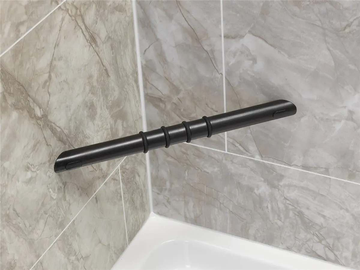 Black grab bar installed on a marble-patterned shower wall for bathroom safety