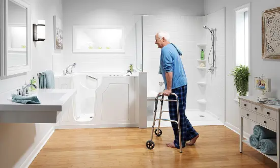Senior with walker demonstrating need for accessible bathroom